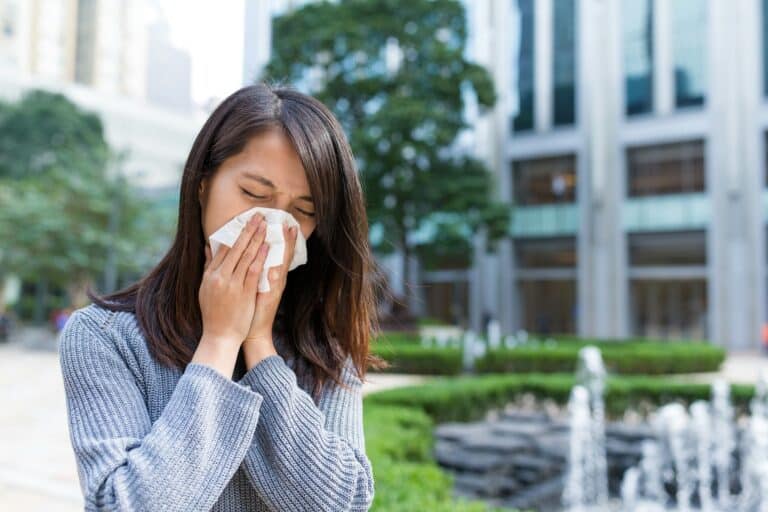 Woman sneeze at outdoor